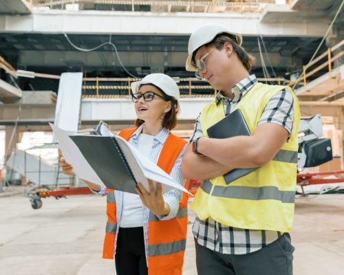 female-construction-inspector-examining-construction-site-